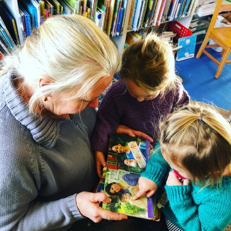 My mother at storytime with my daughters, a critical activity before they were old enough for preschool